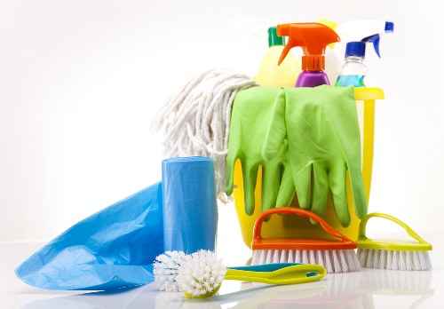 Vacuuming a sofa during routine home cleaning