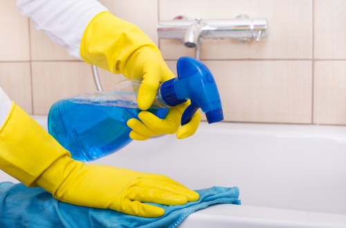 Technician performing steam carpet cleaning in a home room